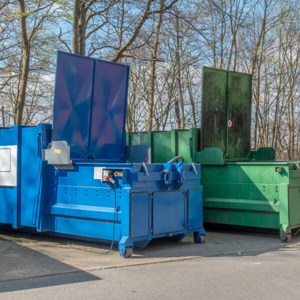 two,large,garbage,compactors,standing,on,a,hospital,site